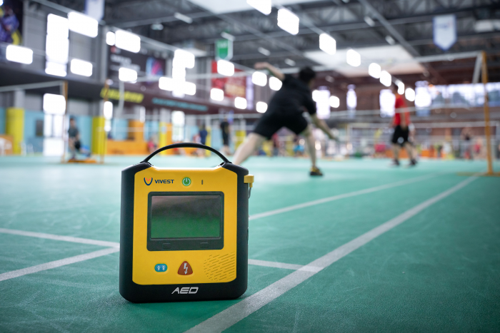 ViVest X3 defibrillator mounted in a sports hall for emergency cardiac response